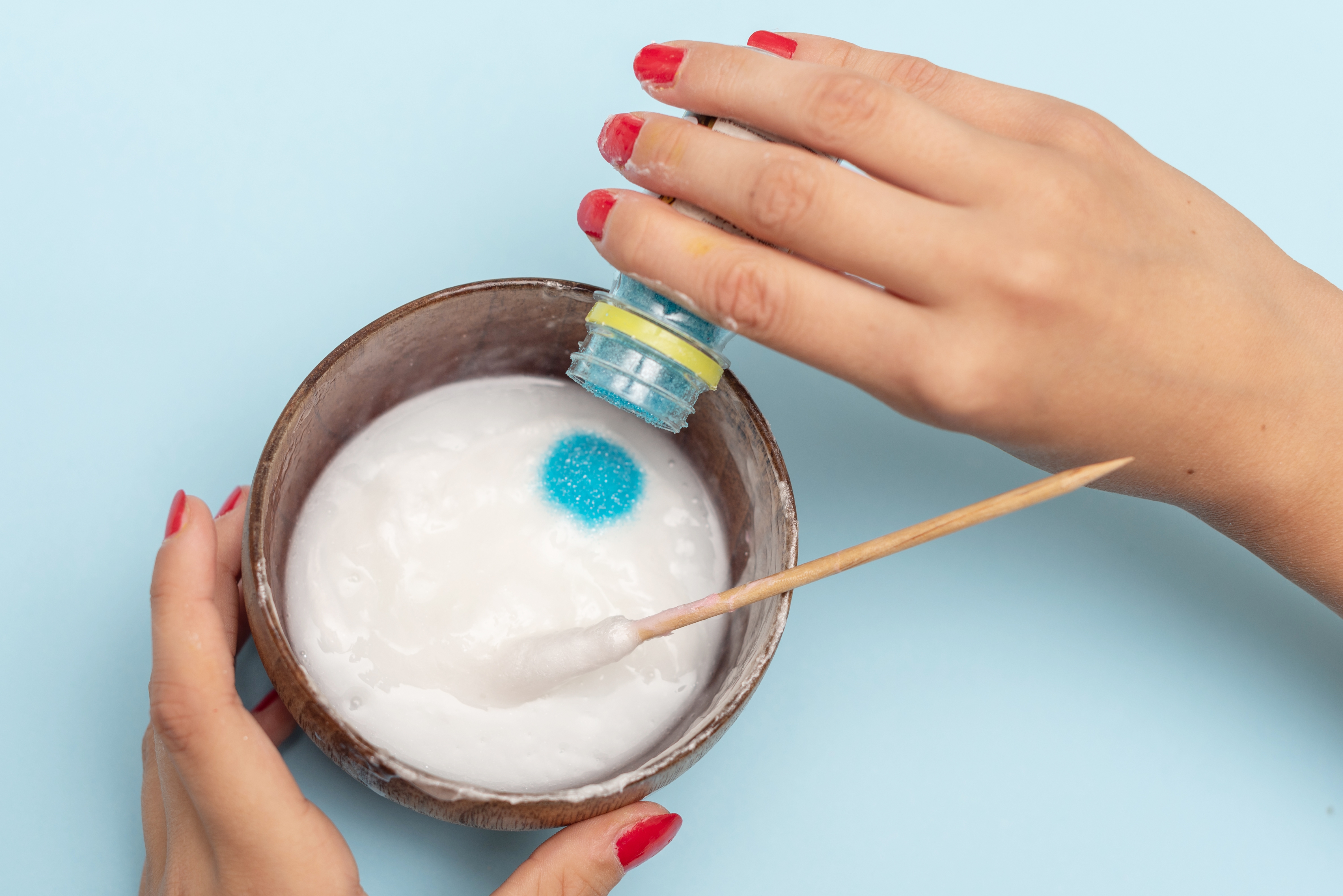 Woman making slime in a bowl